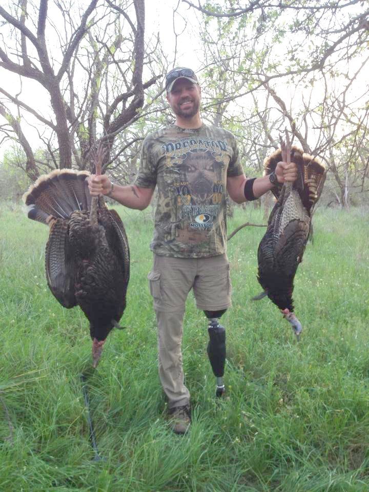 SSG Michael Burns with two turkeys with one shot