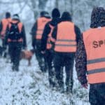 Hunters Hunting in winter wearing blaze orange hunting clothing