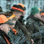 Hunters Hunting in winter wearing blaze orange hunting clothing
