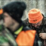 Hunters Hunting in winter wearing blaze orange hunting clothing