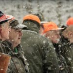 Hunters Hunting in winter wearing blaze orange hunting clothing
