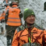 Hunters Hunting in winter wearing blaze orange hunting clothing