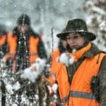 Hunters Hunting in winter wearing blaze orange hunting clothing