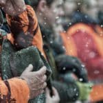 Hunters Hunting in winter wearing blaze orange hunting clothing