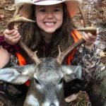 A Happy Little Youth Hunter Girl with a Big Smile, as she shows off the 8 point buck she shot during the deer hunting season | Hunting Magazine