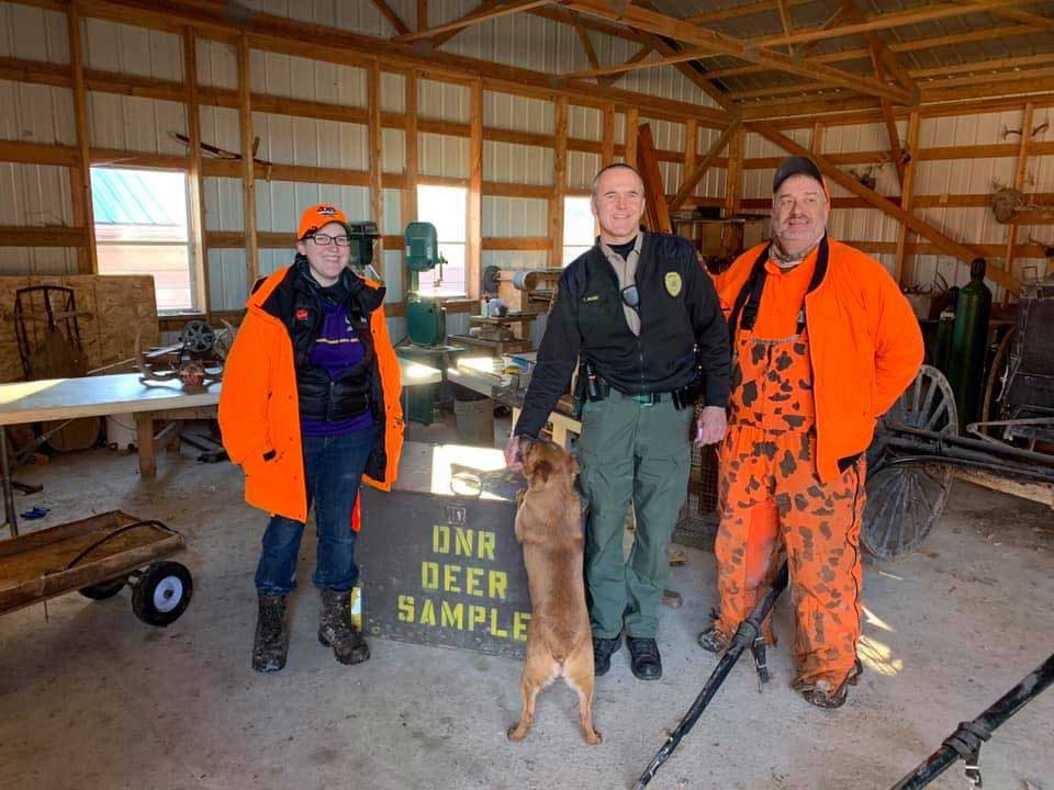 Rep. Jamie Becker Finn (left) and Rep. Rick Hansen (right) with a DNR Conservation Officer (center) at a CWD response station in 2019. Source: Rep. Rick Hansen