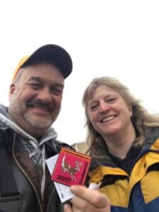Rep. Rick Hansen (left) and Dr. Michelle Carstensen, Minnesota DNR (right), with a 2017 DNR “cooperator” patch after testing wild deer for chronic wasting disease. Source - Rep. Rick Hansen - Hunting Magazine